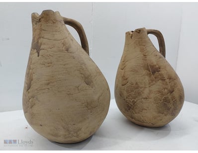 Pair of terracotta vessels featuring characteristi...