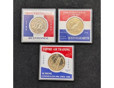 THREE COMMEMORATIVE COINS IN CASES

Includes The...