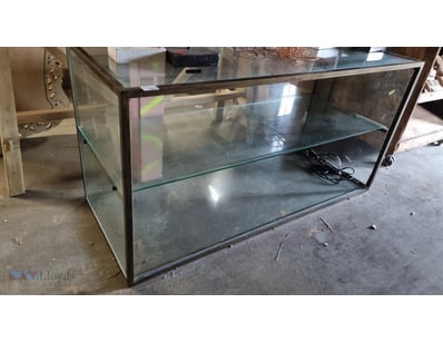 Glass display cabinet with metal frame featuring o...