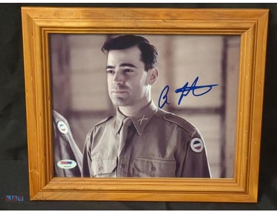 THIS IMAGE FEATURES A FRAMED, AUTOGRAPHED PHOTO OF...