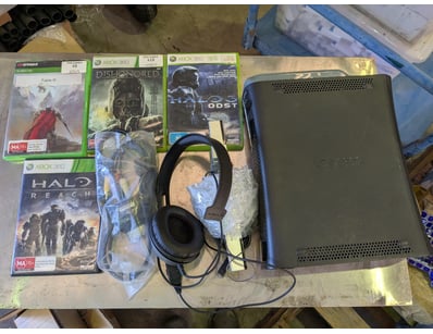 Xbox 360 console bundle featuring a black/dark gre...