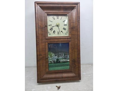 A vintage wooden wall clock featuring a two-part d...