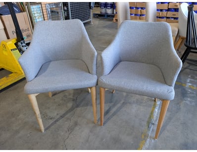 Pair of dining chairs featuring light grey upholst...
