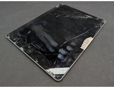 iPad Model A1460 featuring a severely damaged disp...