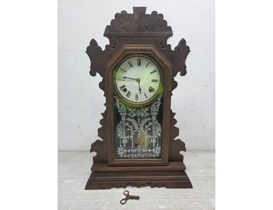Victorian-era shelf or mantel clock featuring orna...
