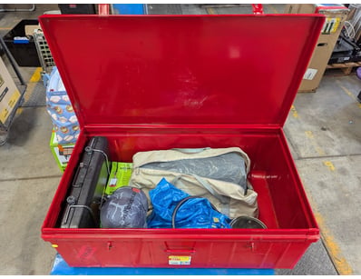 Red metal storage trunk containing comprehensive c...