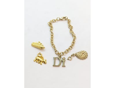 FAUX GOLD BRACELET WITH CHARMS

Condition: Good - ...