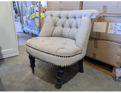 Classic barrel-back accent chair featuring button-...