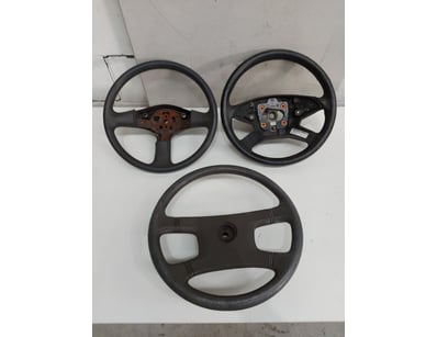 Lot of three car steering wheels, featuring mixed ...