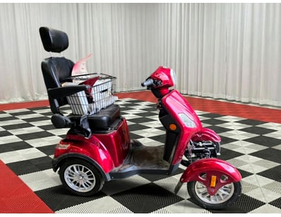 REEF brand three-wheeled mobility scooter in red. ...