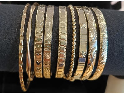 SET OF 9 GOLD COLORED ENGRAVED BANGLES         

C...
