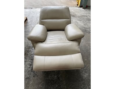 Cream leather recliner chair . Features padded arm...