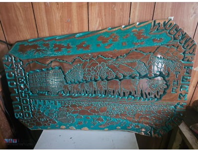 Handcrafted wooden carving featuring a team of bul...