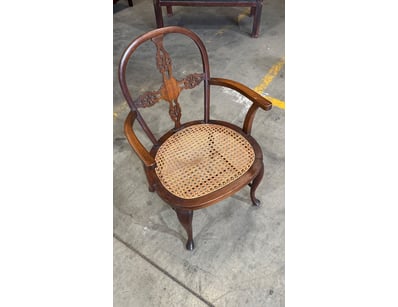 Elegant antique timber armchair featuring ornate c...