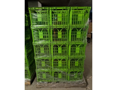 Bulk lot of stackable plastic produce crates in br...