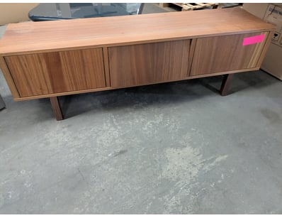 Modern credenza featuring three cabinet doors with...