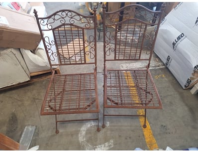 Two metal chairs, metal backings with detailed spi...