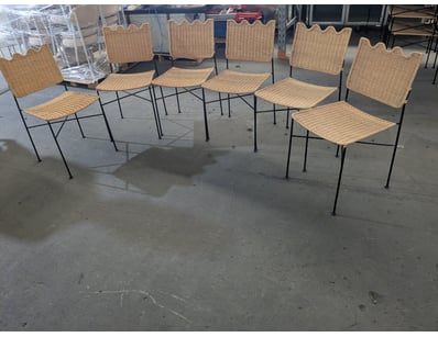 Rattan dining chairs featuring natural woven seats...