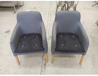 Pair of modern upholstered armchairs featuring a c...