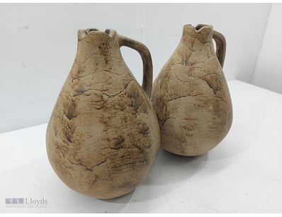 Pair of terracotta vessels featuring characteristi...