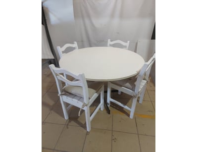white circular dining table with four matching cha...