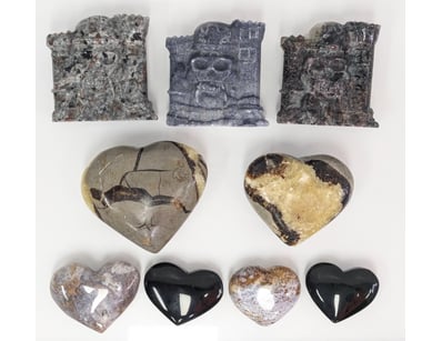 COLLECTION OF STONE SKULL CARVINGS AND POLISHED HE...