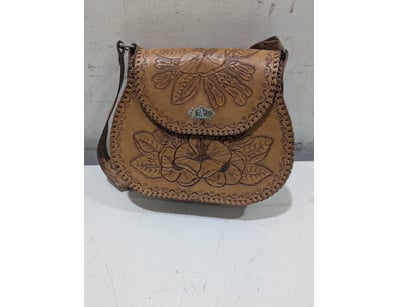 Vintage like tooled leather shoulder bag featuring...