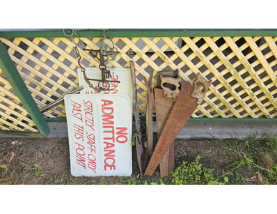 Assorted farming tools and signs, including axe, s...