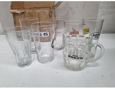 Collection of 7 promotional glassware items featur...