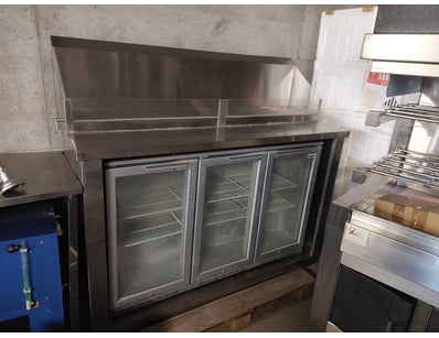 Commercial-grade stainless steel bench with integr...