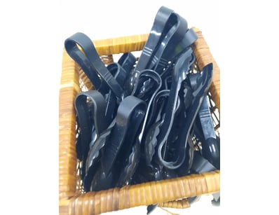 Tongs, black plastic finish.

Unknown quantity....