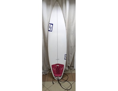 Surfboard featuring white fiberglass construction ...