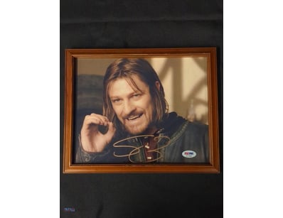 THIS IMAGE FEATURES A FRAMED, AUTOGRAPHED PHOTO OF...