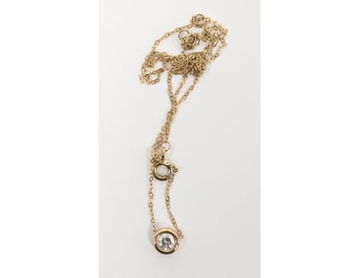 10k gold necklace featuring a delicate cable chain...