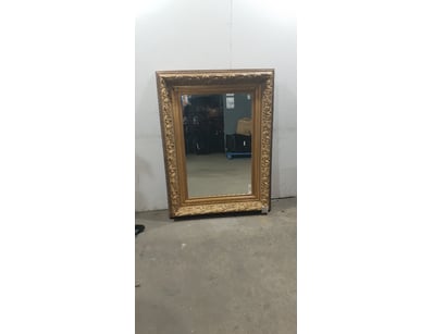 Ornate gilt-framed mirror featuring elaborate Baro...