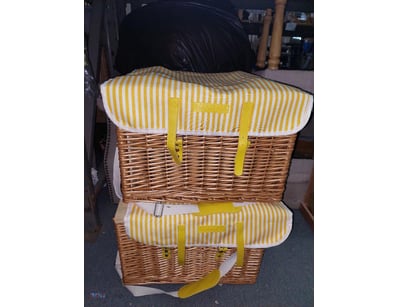 Wicker picnic baskets featuring natural woven cons...