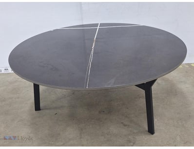 Modern dining table featuring a large glass top, b...