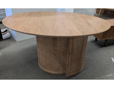Contemporary round dining table featuring a light ...