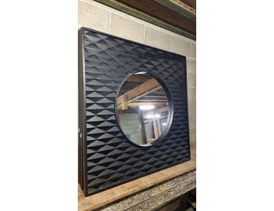 Contemporary square wall mirror featuring a striki...