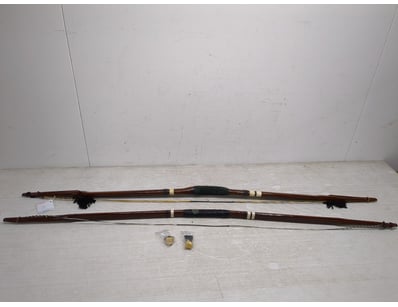 Pair of traditional wooden bows featuring dark tim...