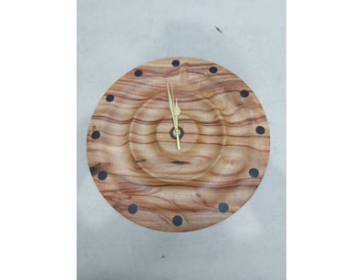 Handcrafted wooden wall clock featuring a round fa...