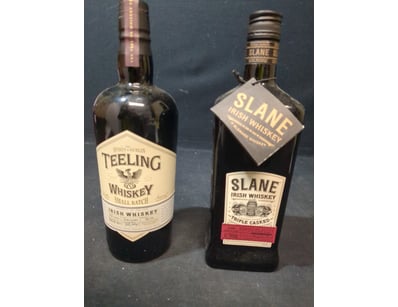 Lot comprising two bottles of Irish whiskey. First...
