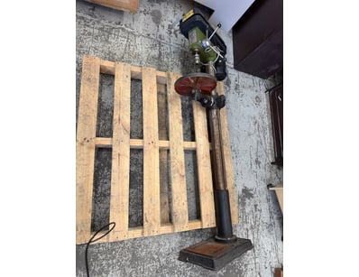 Vintage industrial bench-mounted drill press featu...