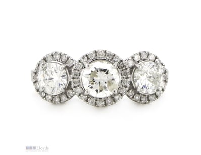 14K WHITE GOLD AND DIAMOND, HALO TRILOGY RING.    ...