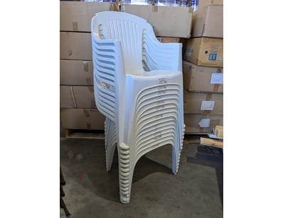 Bulk lot of white plastic stacking chairs with arm...
