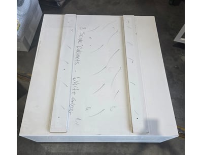 White scale cabinet with storage.