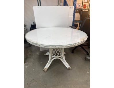 Vintage round pedestal dining table featuring a wh...