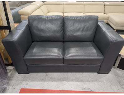 Modern two-seater leather lounge suite featuring c...