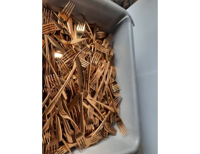 Container of assorted forks and knives, gold finis...