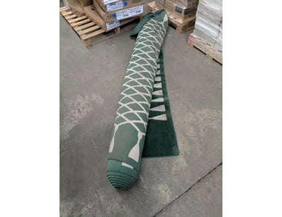 Green and cream geometric patterned carpet roll fe...